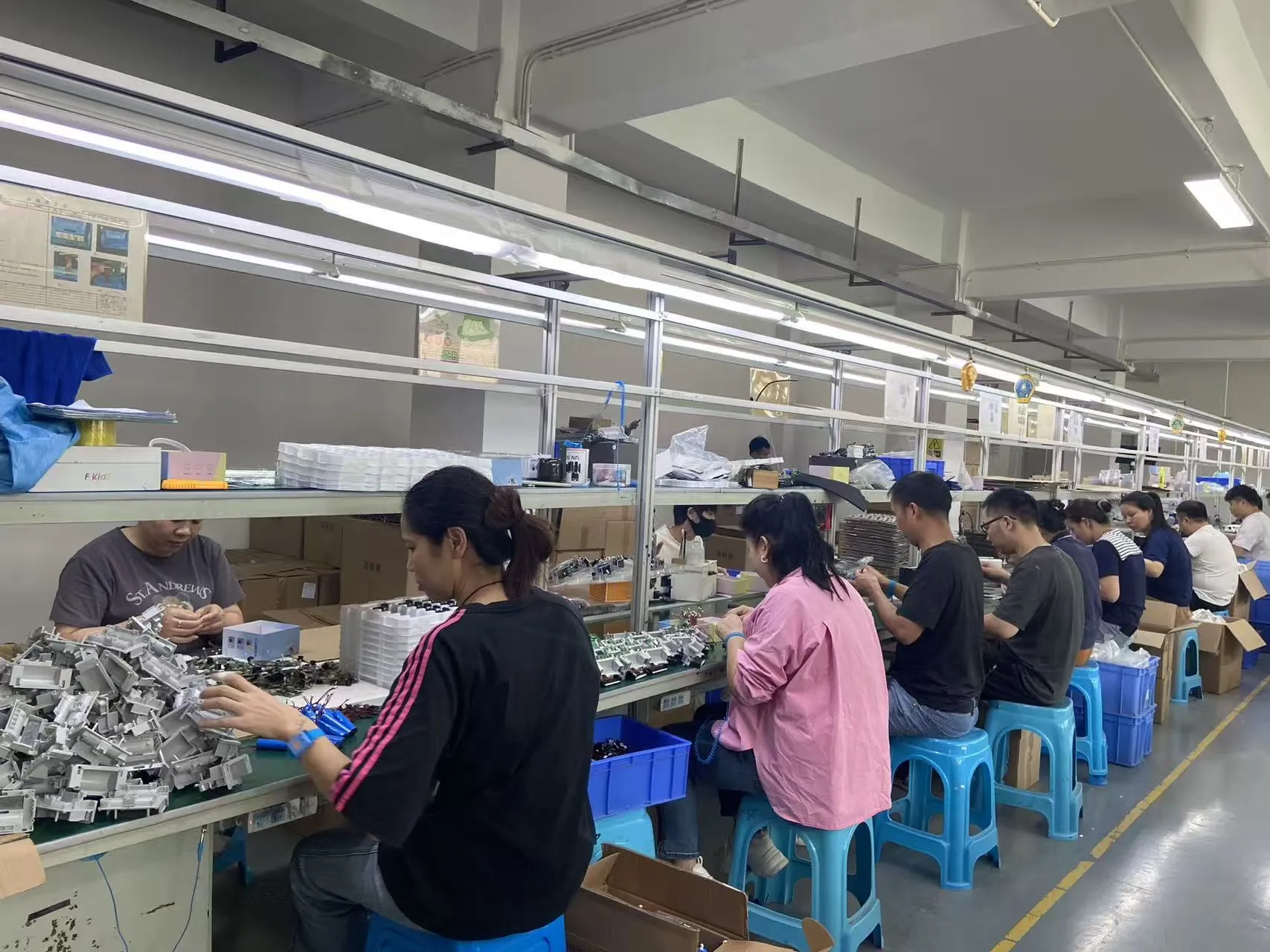 Workers on the camera assembly line at JSRD